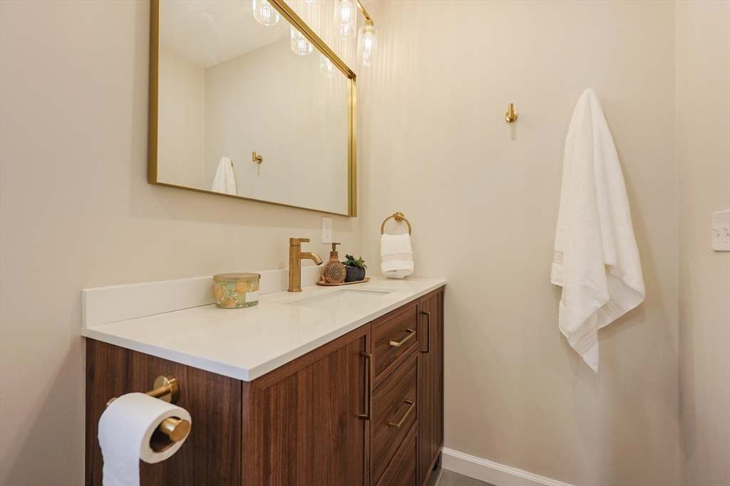 81 Elliott Street Danvers, MA 01923 - Photo 19 of 31 a bathroom with a sink vanity and a mirror