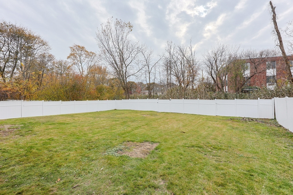 81 Elliott Street Danvers, MA 01923 - Photo 25 of 31 a view of yard with swimming pool and trees in the background