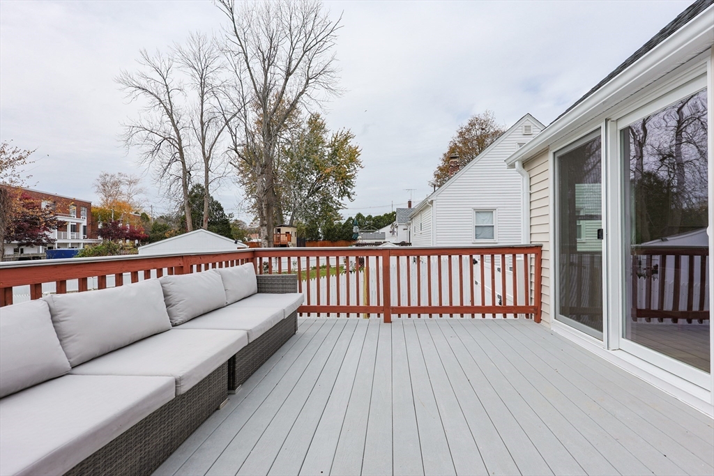 81 Elliott Street Danvers, MA 01923 - Photo 26 of 31 a balcony with wooden floor and outdoor seating