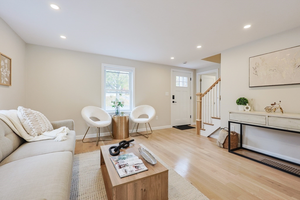 81 Elliott Street Danvers, MA 01923 - Photo 7 of 31 a living room with furniture a window and gym equipment