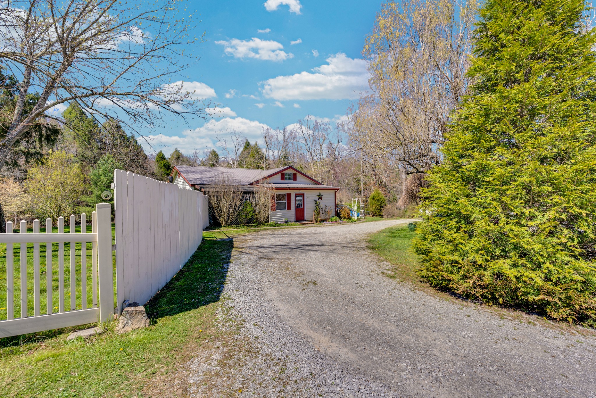 105 Dripping Springs Road Monterey, TN 38574 - Photo 2 of 49 a view of a house with a small yard and large trees
