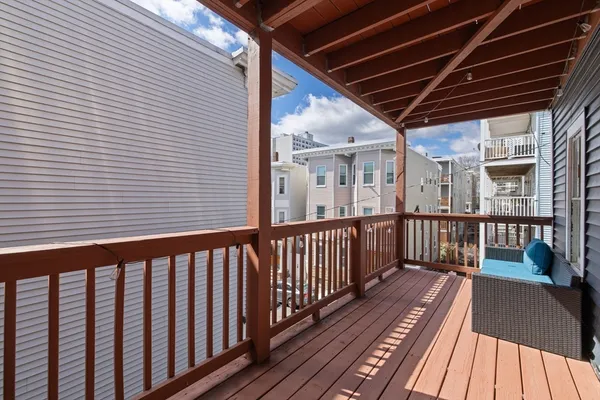 a view of a balcony with wooden floor