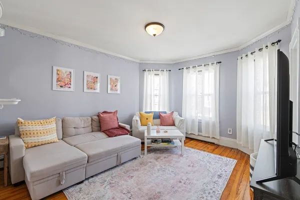 a living room with furniture and a rug