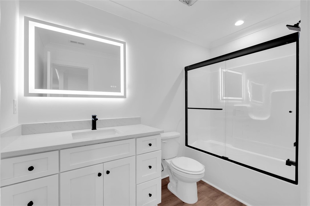407 Blue Ridge Court Westminster, SC 29693 - Photo 30 of 48 This clean and bright bathroom features a modern vanity and a sleek shower-tub combination.