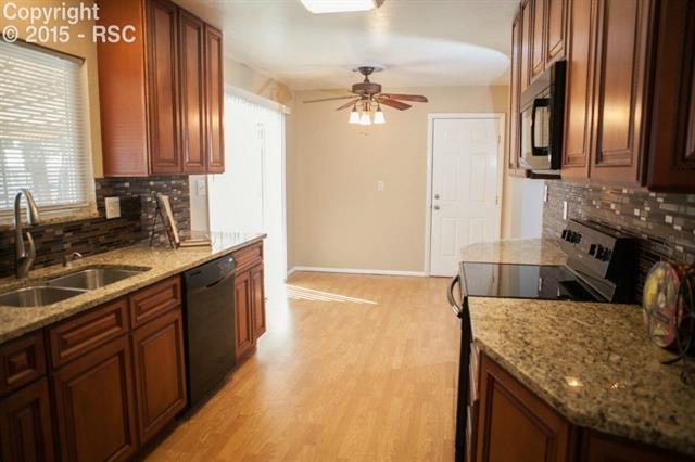 6965 Chippewa Road Colorado Springs, CO 80915 - Photo 1 of 31 Slab granite, glass tile backsplash, and all new 45' Maple Cabinets and pantry. Brand new water and light fixtures throughout!
