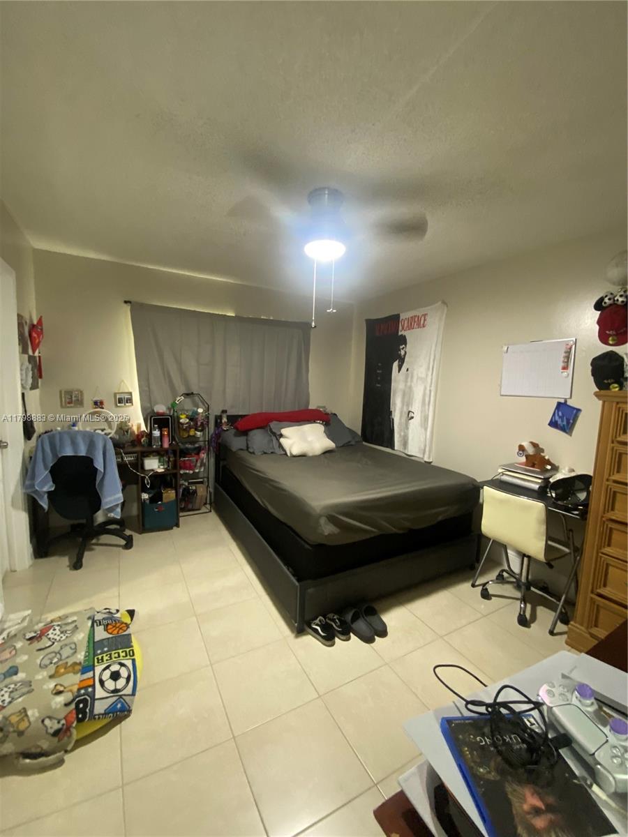 Gardens North Condominium Pompano Beach, FL 33069 - Photo 13 of 31 a bedroom with a bed and a dresser