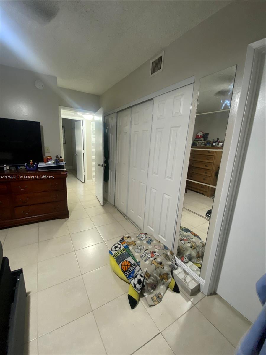Gardens North Condominium Pompano Beach, FL 33069 - Photo 17 of 31 a living room with furniture and a flat screen tv