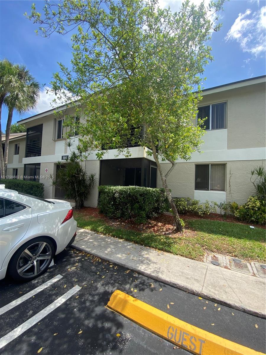 Gardens North Condominium Pompano Beach, FL 33069 - Photo 2 of 31 a view of a car parked in front of a house