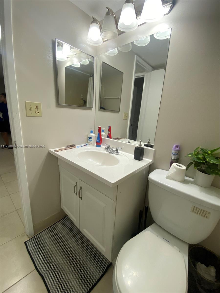 Gardens North Condominium Pompano Beach, FL 33069 - Photo 22 of 31 a bathroom with a sink mirror and toilet