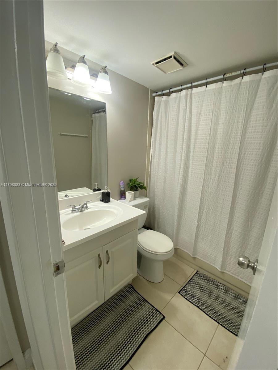 Gardens North Condominium Pompano Beach, FL 33069 - Photo 24 of 31 a bathroom with a sink a toilet and shower
