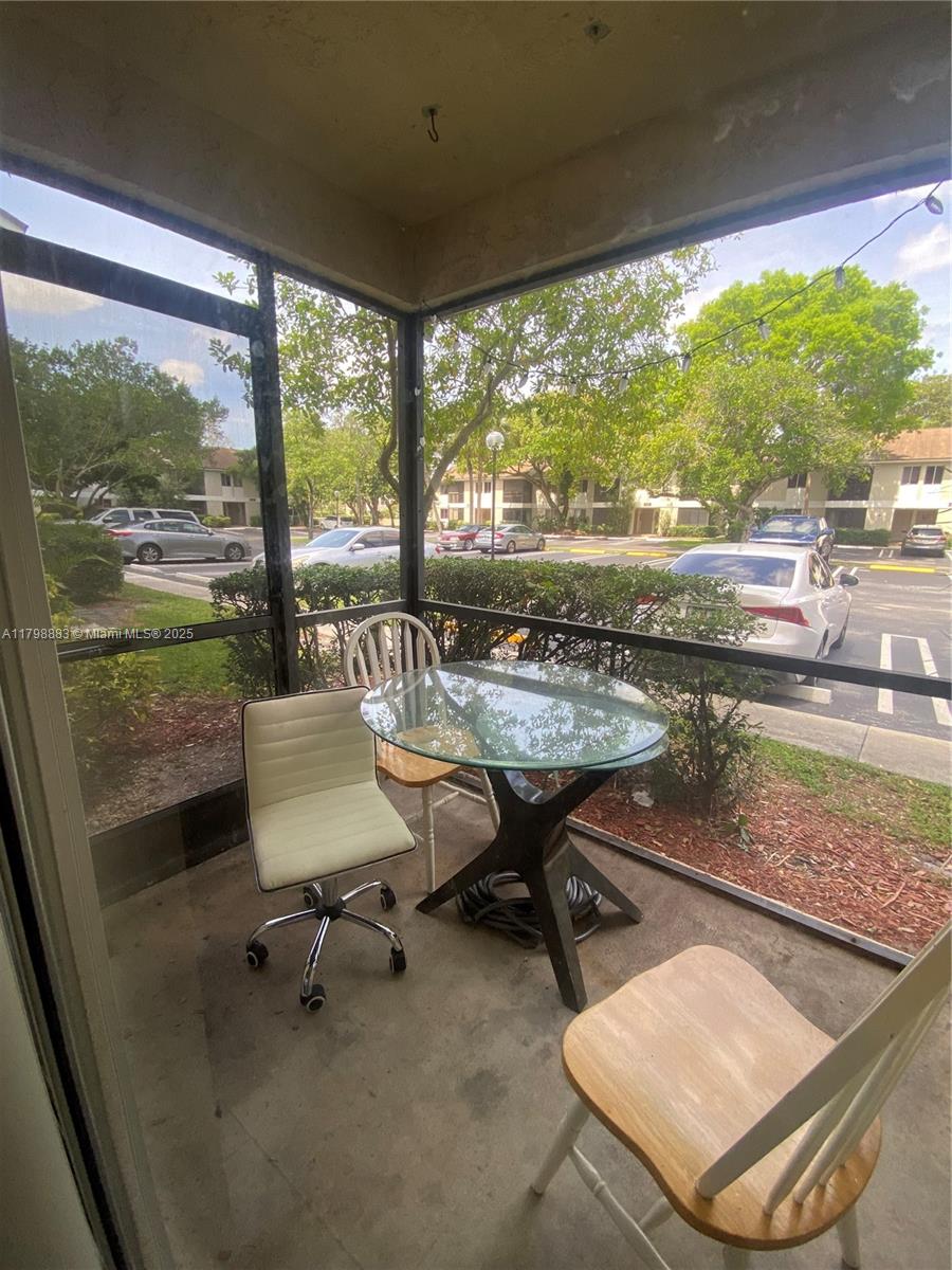 Gardens North Condominium Pompano Beach, FL 33069 - Photo 26 of 31 a dining room with a table and chairs