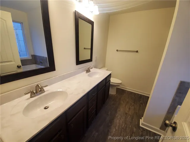 a bathroom with a double vanity sink and a mirror