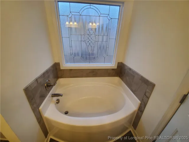 a bathroom with a tub and shower