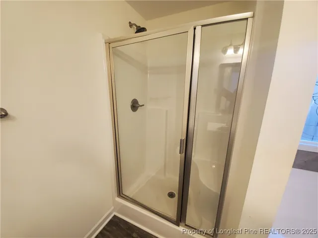 a bathroom with a glass door shower
