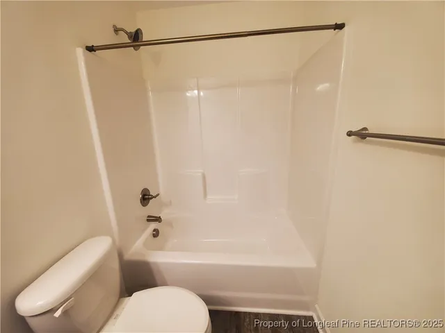a bathroom with a toilet and a bathtub