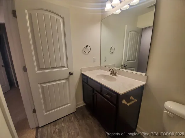 a bathroom with a sink vanity and a mirror