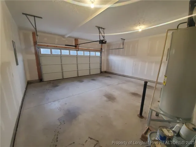 an empty room with windows and fireplace