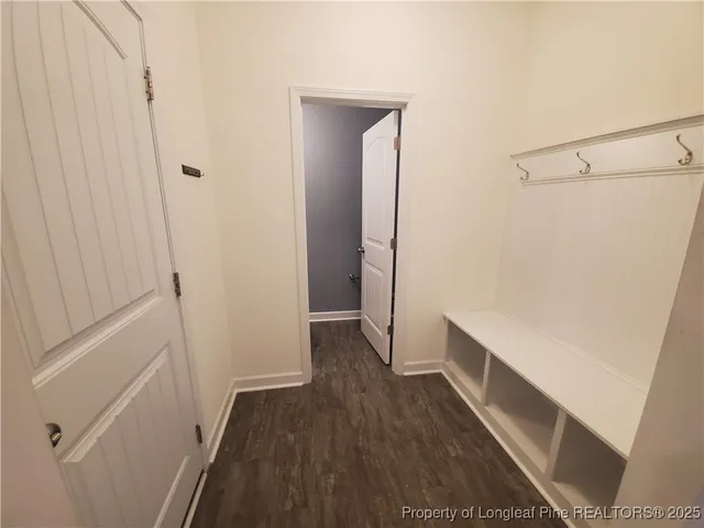 a view of walk in closet with wooden floor