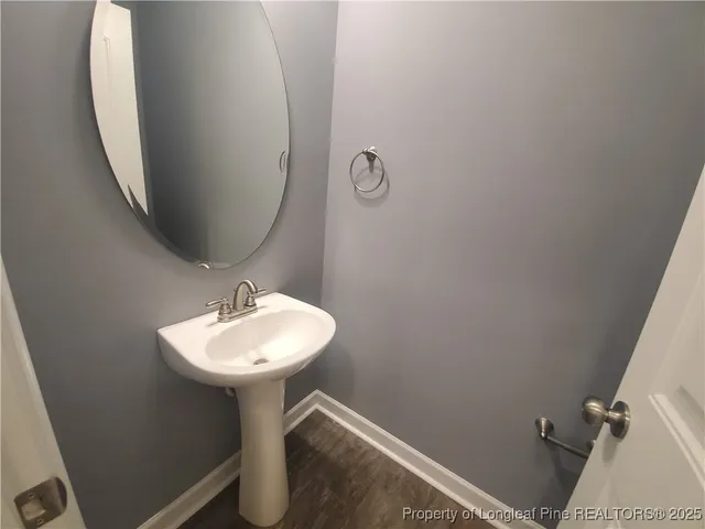 a bathroom with a sink toilet and a mirror