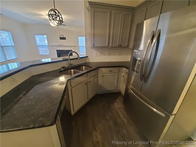 a kitchen with a sink a refrigerator and a stove