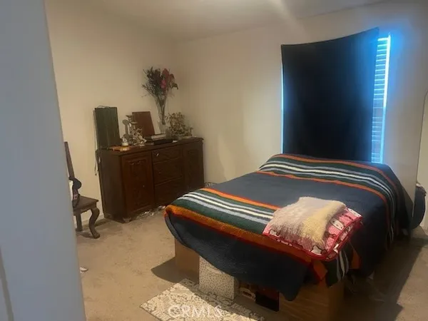 a bedroom with a bed and dresser