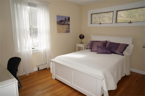 245 Harvard Road Stow, MA 01775 - Photo 6 of 12 a bedroom with a bed and wooden floor