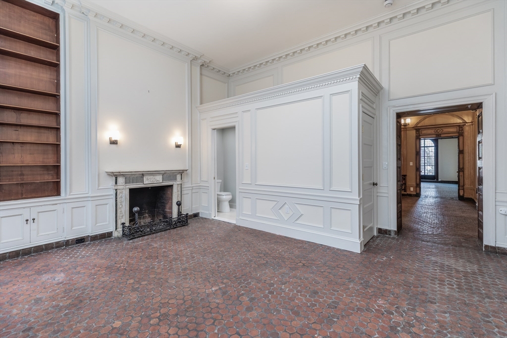 107 Beacon Street, Unit 3 Boston, MA 02116 - Photo 17 of 26 a view of an empty room with fireplace and a window