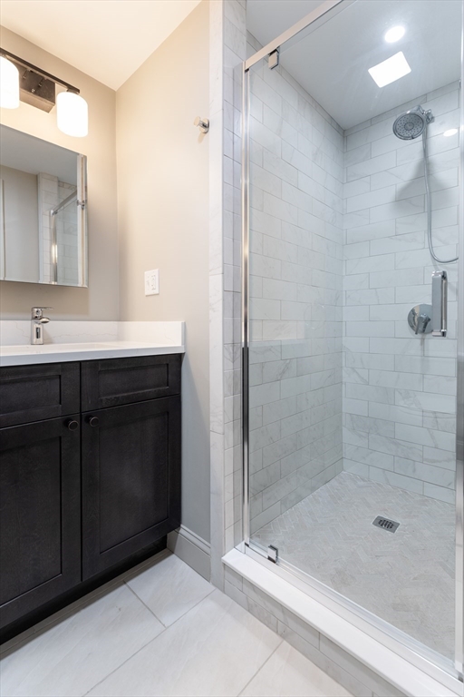 107 Beacon Street, Unit 3 Boston, MA 02116 - Photo 18 of 26 a bathroom with a shower sink and mirror