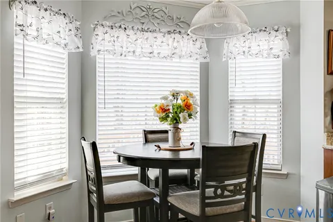 a dining room with furniture and window