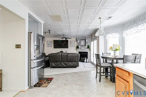 a living room with furniture a flat screen tv and a table