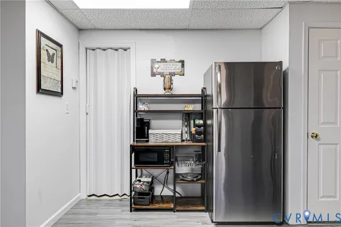 a kitchen with refrigerator and table