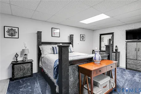 a bedroom with bed and a chandelier