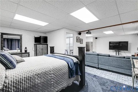 a bedroom with a bed and flat screen tv