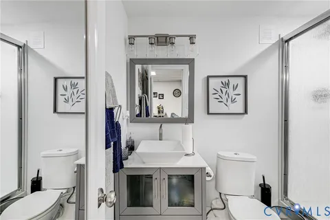 a bathroom with a sink toilet and mirror