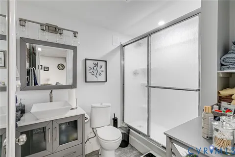 a bathroom with a sink toilet and shower
