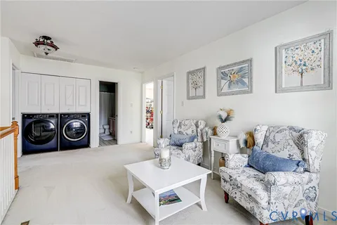 a living room with furniture and a washing machine
