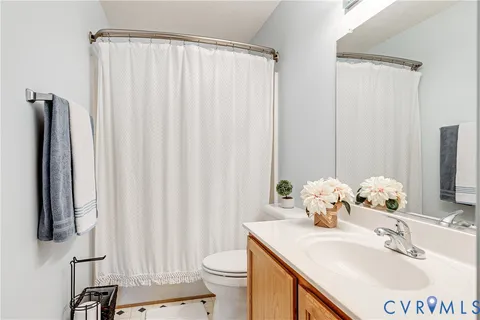 a bathroom with a sink vanity mirror and toilet