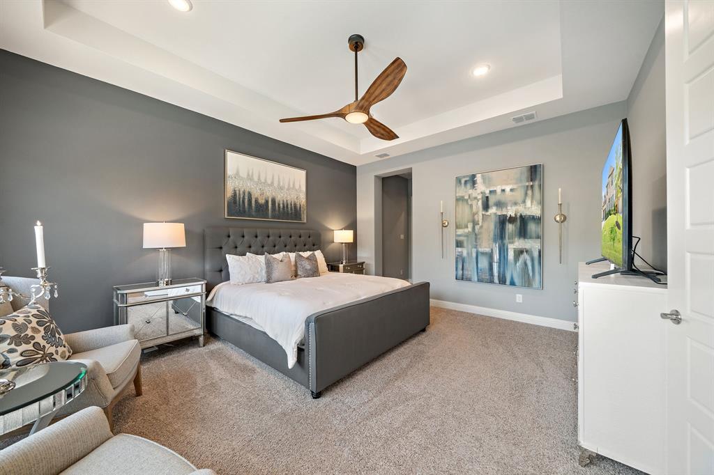 11705 Little Elm Creek Road Flower Mound, TX 76226 - Photo 16 of 39 a spacious bedroom with a large bed and a chandelier
