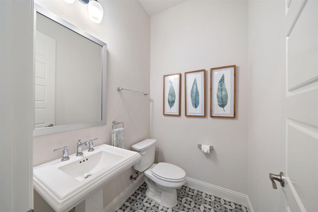 11705 Little Elm Creek Road Flower Mound, TX 76226 - Photo 19 of 39 a bathroom with a sink mirror and toilet