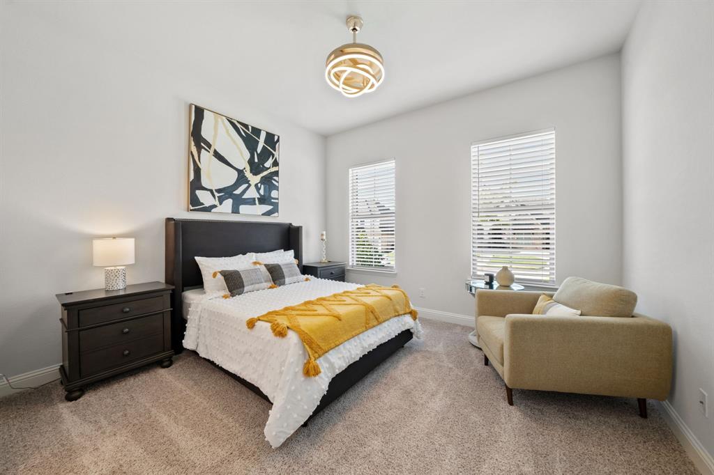 11705 Little Elm Creek Road Flower Mound, TX 76226 - Photo 20 of 39 a bedroom with bed and a couch