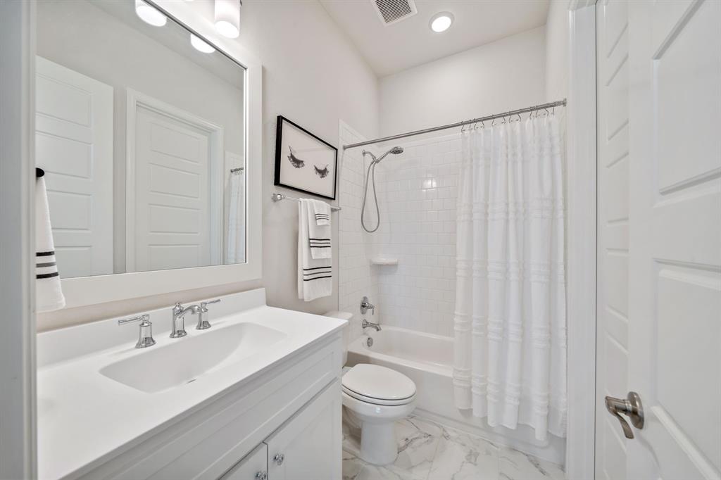 11705 Little Elm Creek Road Flower Mound, TX 76226 - Photo 21 of 39 a bathroom with a sink a toilet and shower