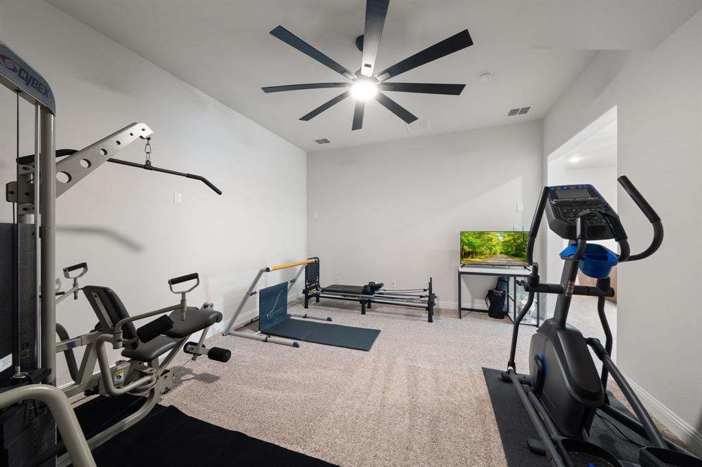 11705 Little Elm Creek Road Flower Mound, TX 76226 - Photo 26 of 39 a room with gym equipment and windows