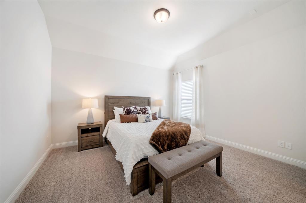 11705 Little Elm Creek Road Flower Mound, TX 76226 - Photo 27 of 39 a bedroom with a bed and a chair