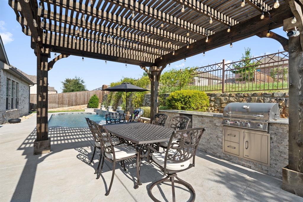 11705 Little Elm Creek Road Flower Mound, TX 76226 - Photo 36 of 39 a view of a patio with table and chairs with wooden floor and fence