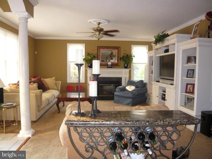 4801 Broom Drive Olney, MD 20832 - Photo 5 of 19 a living room with fireplace furniture and a flat screen tv