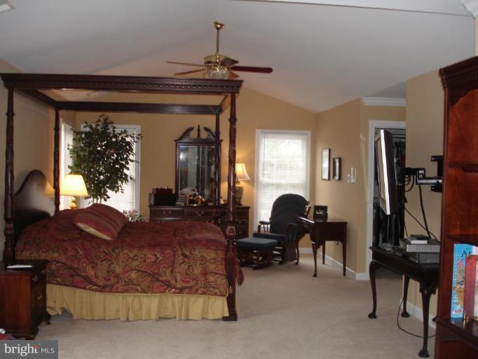4801 Broom Drive Olney, MD 20832 - Photo 7 of 19 a living room with furniture gym equipment and a chandelier