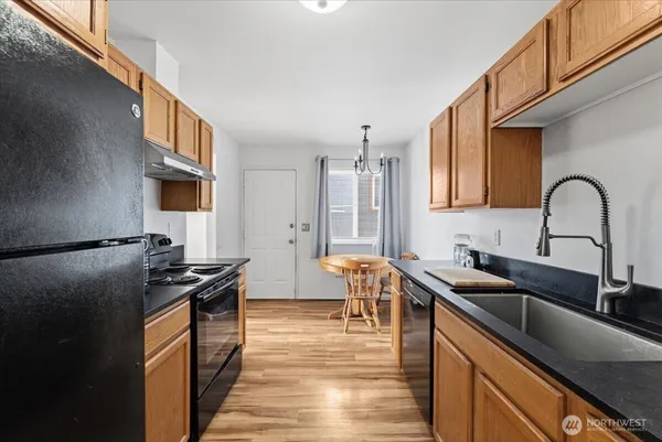 a kitchen with a sink stove and refrigerator