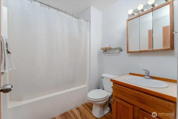 a bedroom with a bed and a potted plant