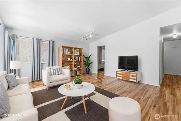 a view of an empty room with wooden floor
