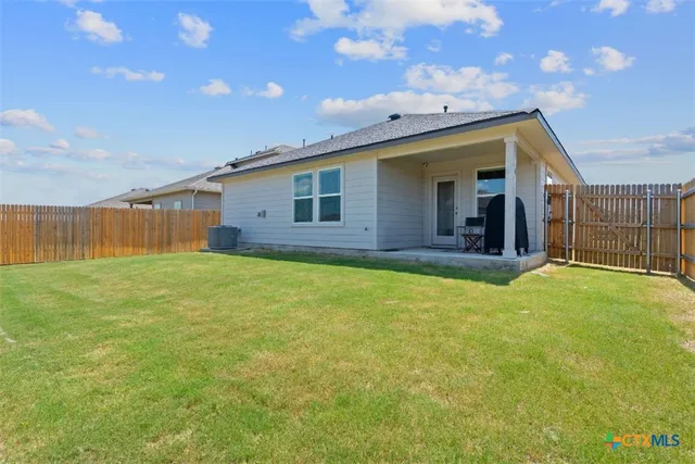 a view of a house with a backyard